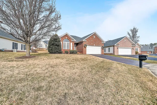 a view of a house with a yard covered in snow