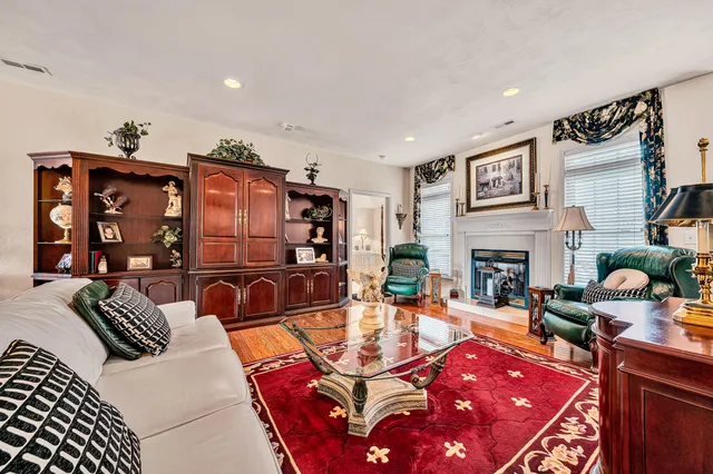 a living room with furniture a rug and a fireplace