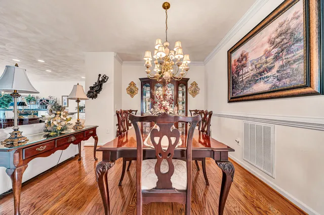 a view of a dining room with furniture and chandelier