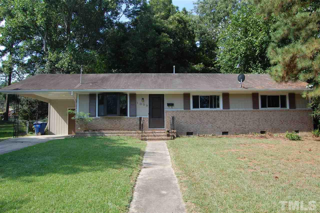 1009 Somerset Road Raleigh, NC 27610 - Photo 1 of 13 a front view of a house with a garden and yard