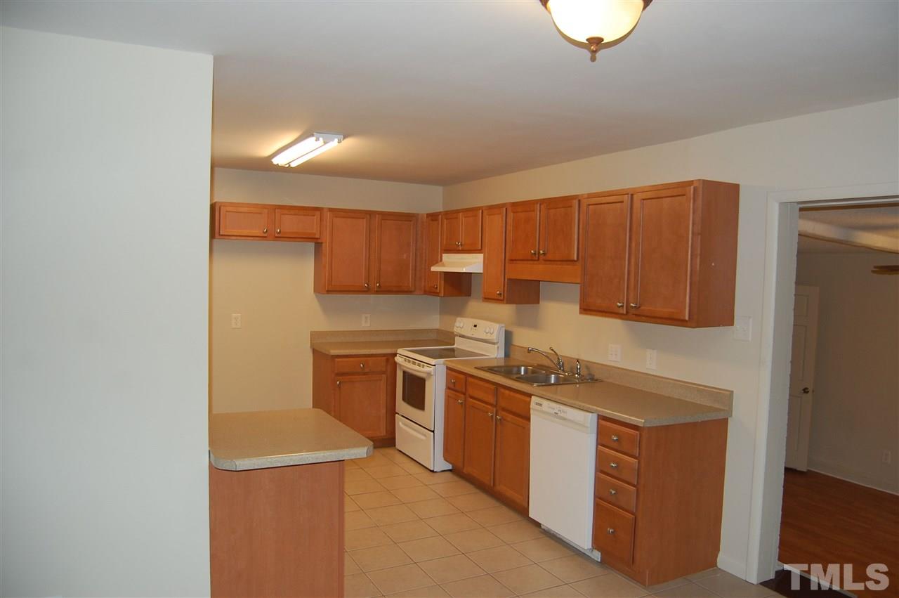 1009 Somerset Road Raleigh, NC 27610 - Photo 6 of 13 a kitchen with stainless steel appliances granite countertop a sink and a stove top oven