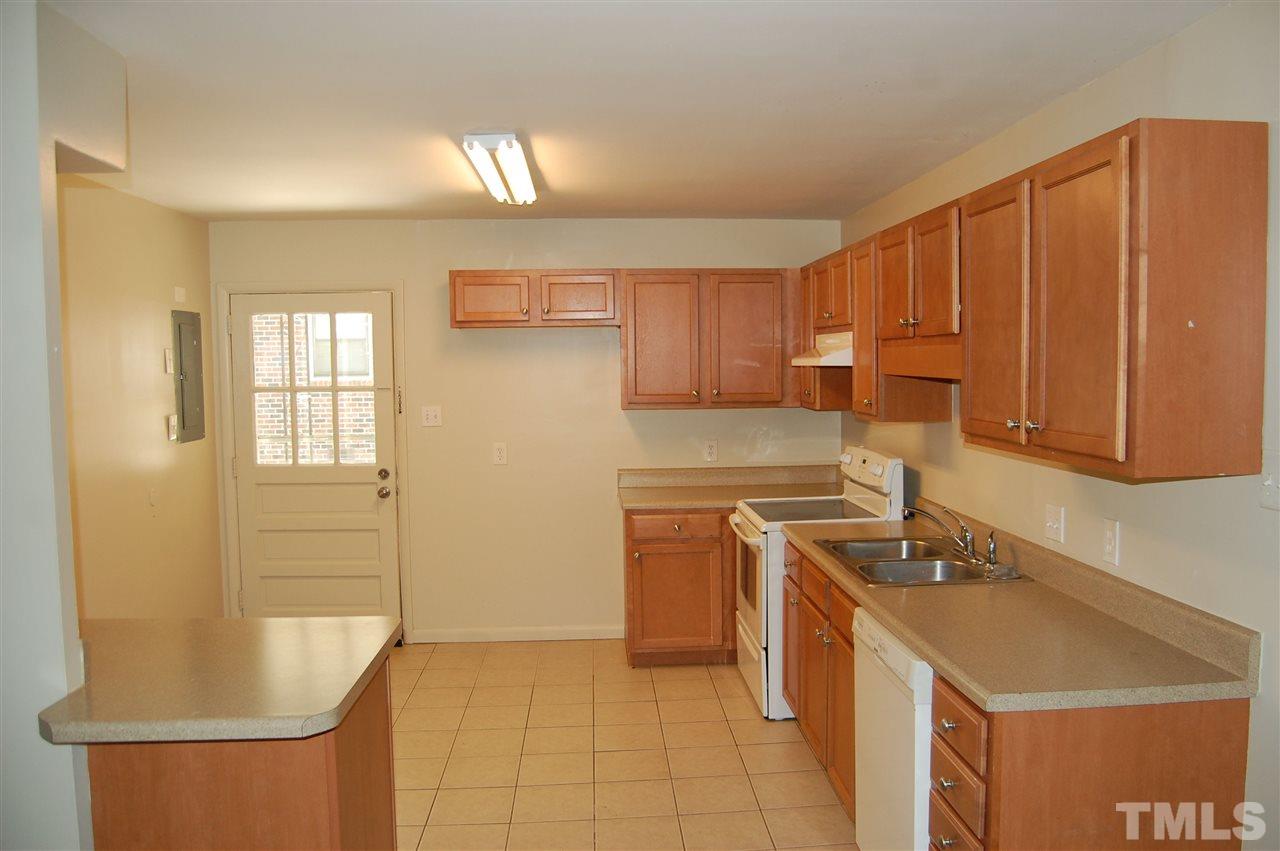 1009 Somerset Road Raleigh, NC 27610 - Photo 8 of 13 a kitchen with stainless steel appliances granite countertop a sink a stove and a refrigerator