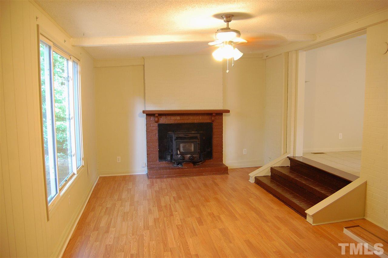 1009 Somerset Road Raleigh, NC 27610 - Photo 9 of 13 a view of a livingroom with a fireplace and window