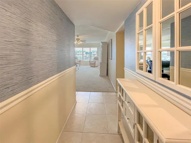 a large white kitchen with a large window