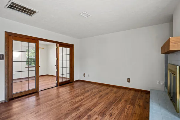wooden floor in an empty room with a window
