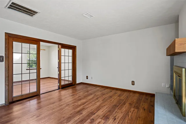 wooden floor in an empty room with a window