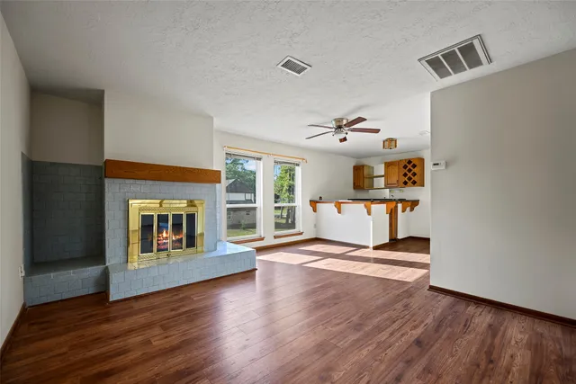 a living room with hardwood floor and a fireplace