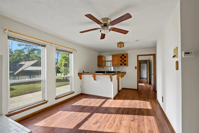 a room with wooden floor and windows