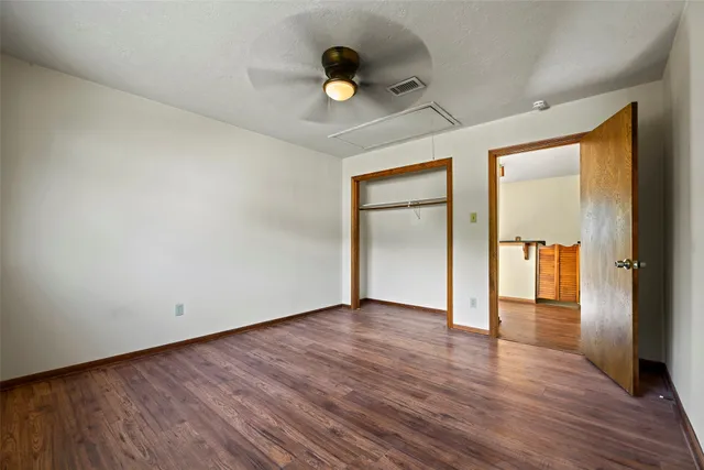 a view of an empty room and wooden floor