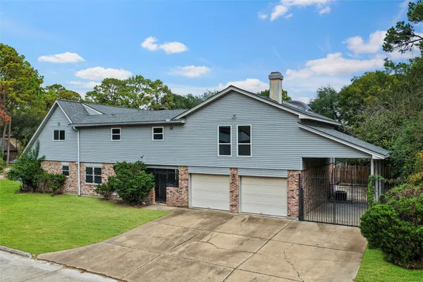 a front view of house with yard and trees
