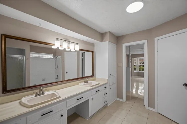 a bathroom with a double vanity sink and a mirror