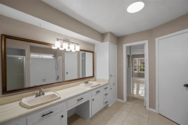 a bathroom with a double vanity sink and a mirror