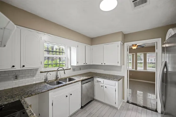 a kitchen that has a sink and a stove in it