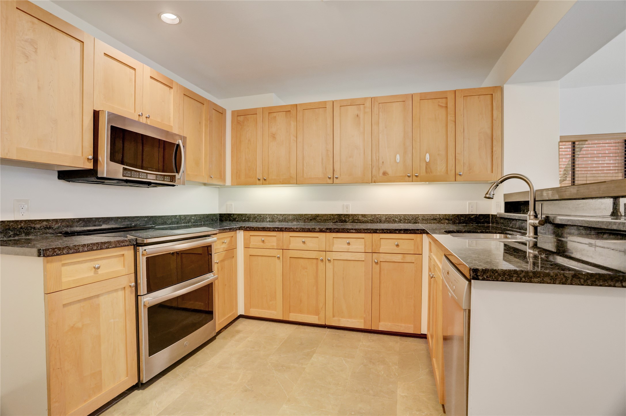 2629 Wroxton Road, Unit A Houston, TX 77005 - Photo 9 of 22 Stylish kitchen with sleek countertops and premium appliances.