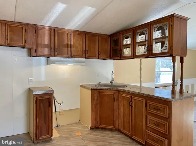 a kitchen with stainless steel appliances granite countertop a sink and a cabinets