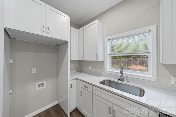 a kitchen with a sink cabinets and window