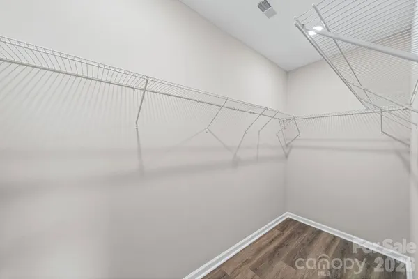 a bathroom with a granite countertop sink vanity mirror and toilet
