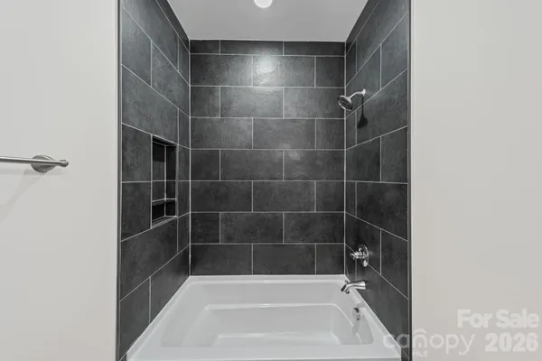 a view of an empty room with a window and a ceiling fan
