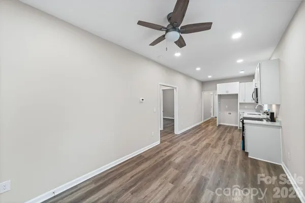 a view of a kitchen with a sink and wooden floor