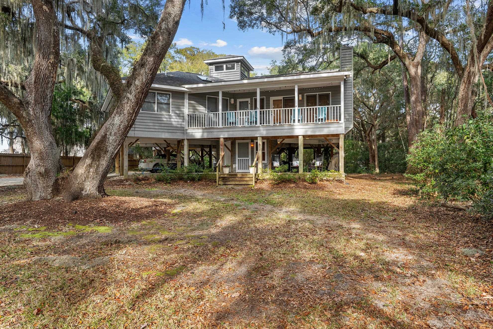 187 Alston Road Pawleys Island, SC 29585 - Photo 1 of 40 Coastal home with a chimney and a wooden deck