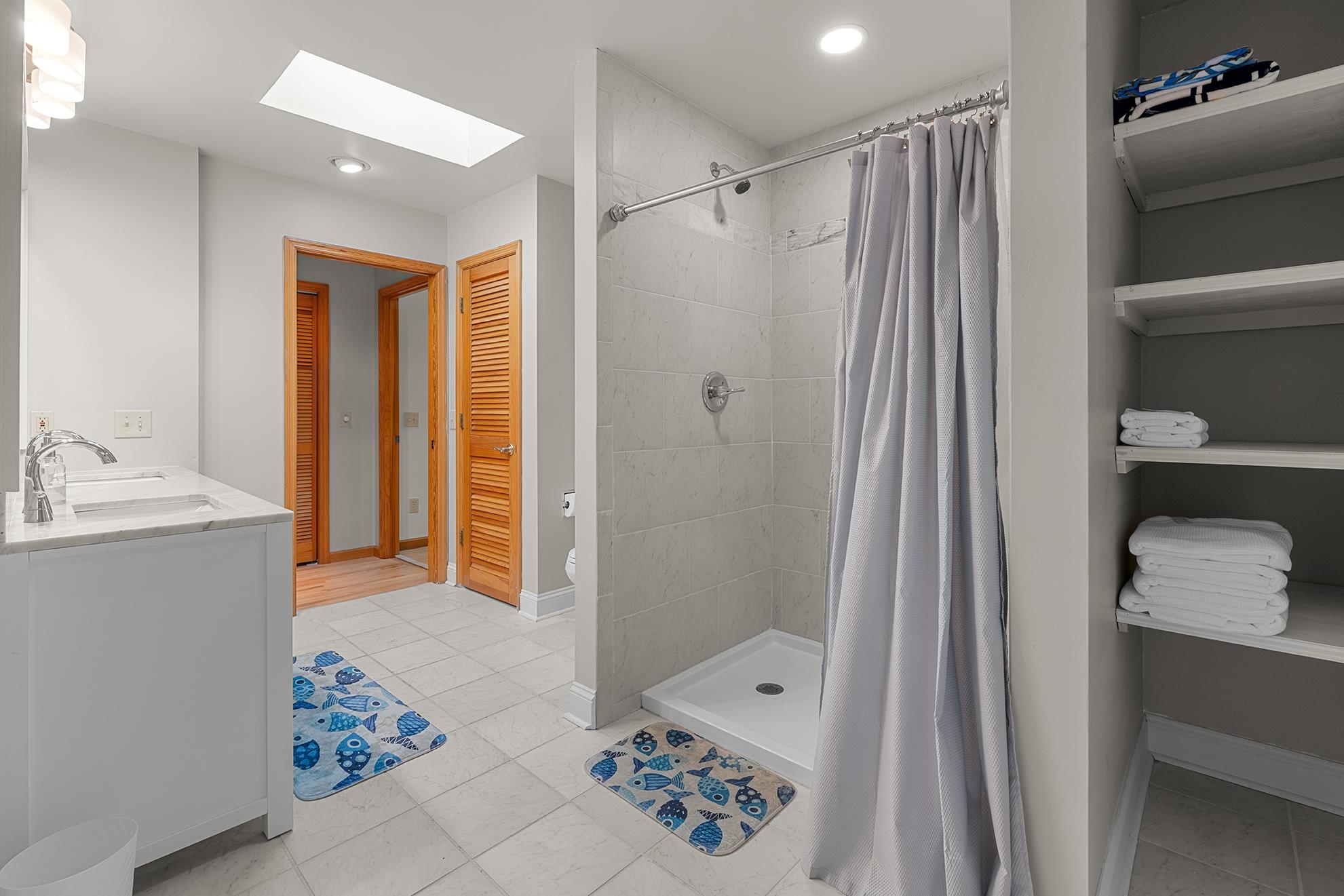 187 Alston Road Pawleys Island, SC 29585 - Photo 25 of 40 Full bath featuring a closet, a stall shower, a skylight, double vanity, and recessed lighting