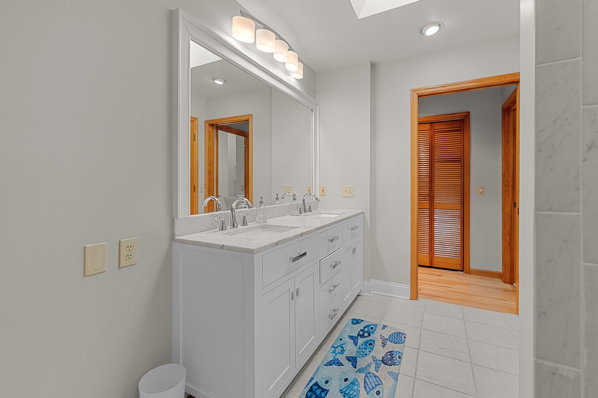 187 Alston Road Pawleys Island, SC 29585 - Photo 26 of 40 Bathroom with double vanity, a skylight, light tile patterned floors, and recessed lighting