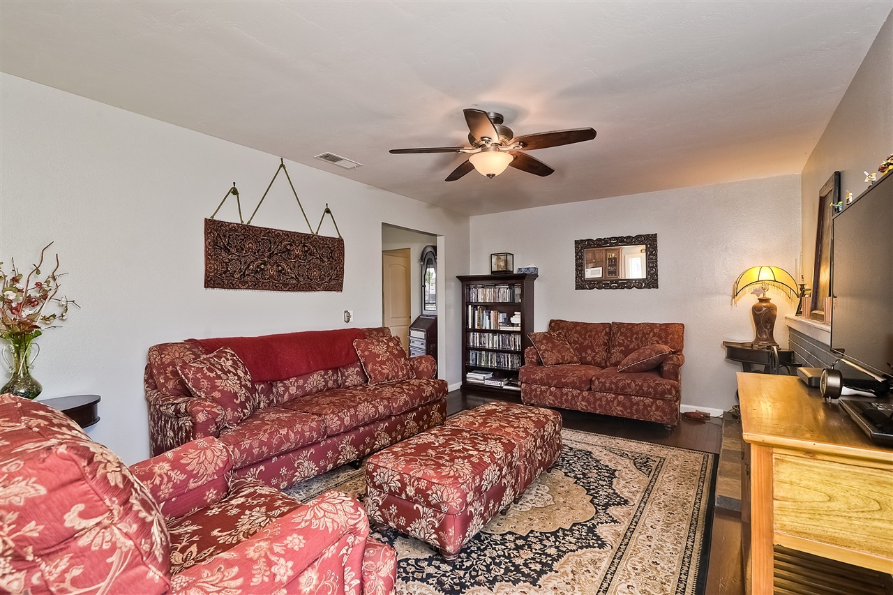 4034 Pala Road Oceanside, CA 92057 - Photo 14 of 22 Family Room with Brick Fireplace and Gorgeous Wood Flooring.