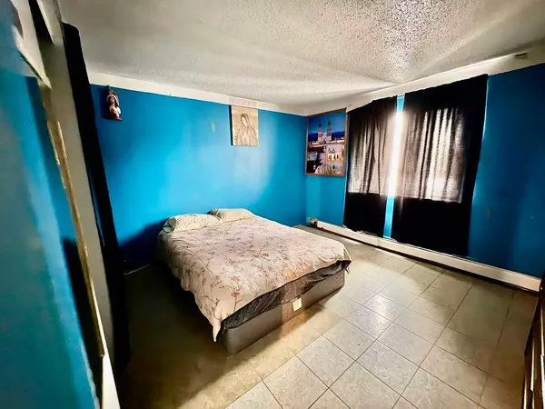 a bedroom with a bed and window
