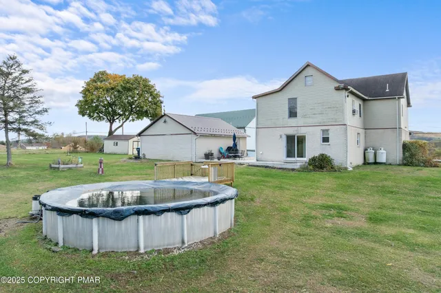 a kitchen with stainless steel appliances granite countertop a refrigerator a sink dishwasher a stove a kitchen island with chairs and wooden floor