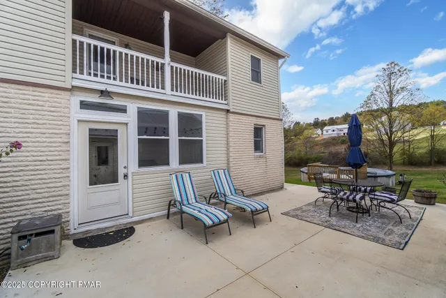 a view of a room with a large window and dining room