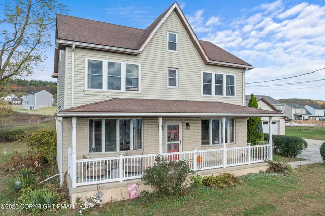 a view of house with garden and tall windows