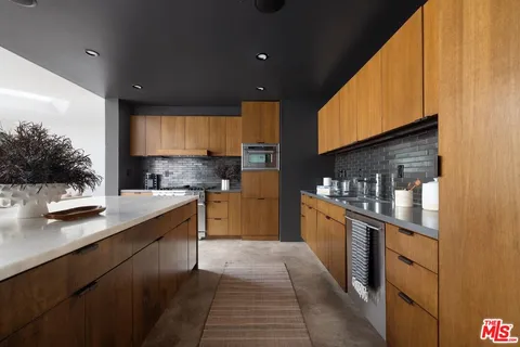 a kitchen with stainless steel appliances granite countertop a sink counter space cabinets and a stove