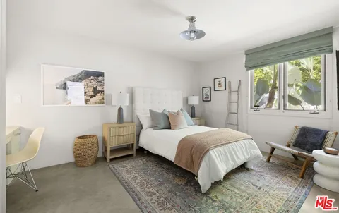 a spacious bedroom with a bed and a couch