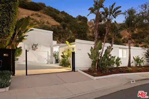 a view of a house with basketball court