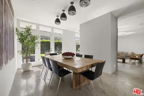 a view of a dining room with furniture and a large window