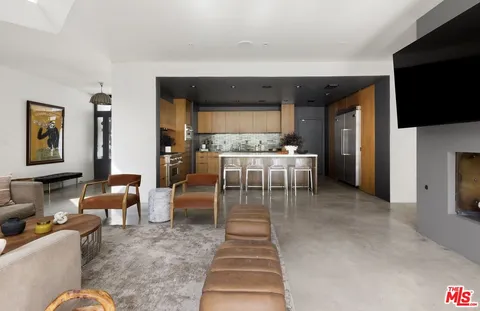 a living room with a couch and a stove top oven