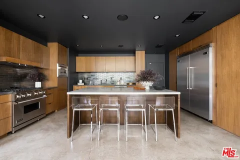 a kitchen with stainless steel appliances kitchen island granite countertop a sink and cabinets