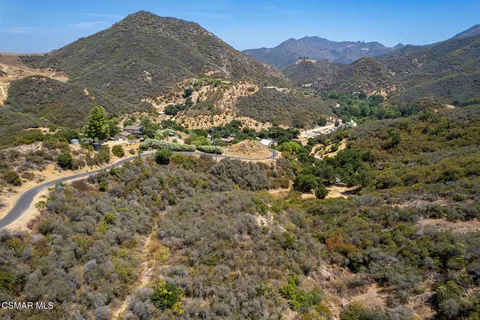 a view of a mountain range with lush green forest