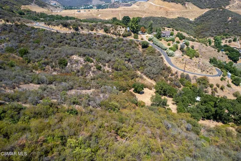 an aerial view of a houses with a yard