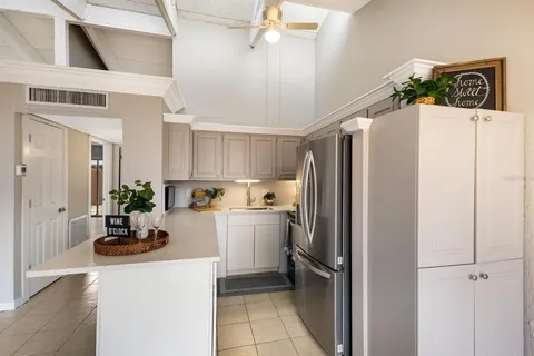 a kitchen with a refrigerator and a sink