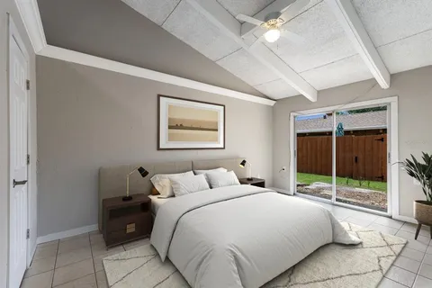 a bedroom with a bed and a large window