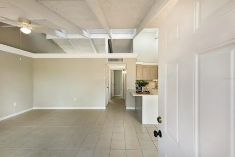 a view of a storage & utility room with refrigerator and windows