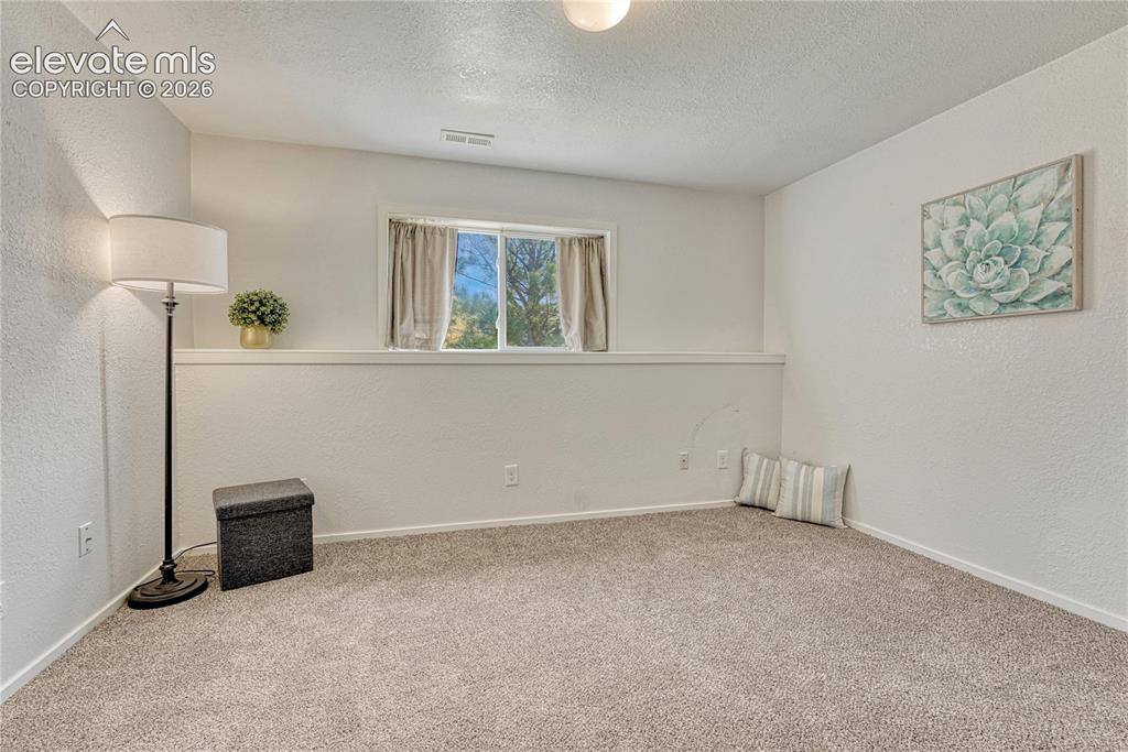 7285 Julynn Road Colorado Springs, CO 80919 - Photo 31 of 45 a view of empty room with windows