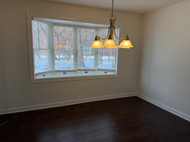 a view of wooden floor and windows in a room