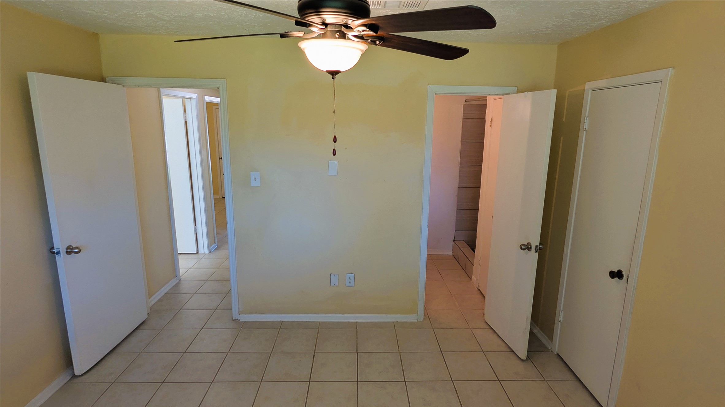 11403 Spring Grove Drive Houston, TX 77099 - Photo 11 of 23 a view of a hallway with a chandelier fan and a refrigerator