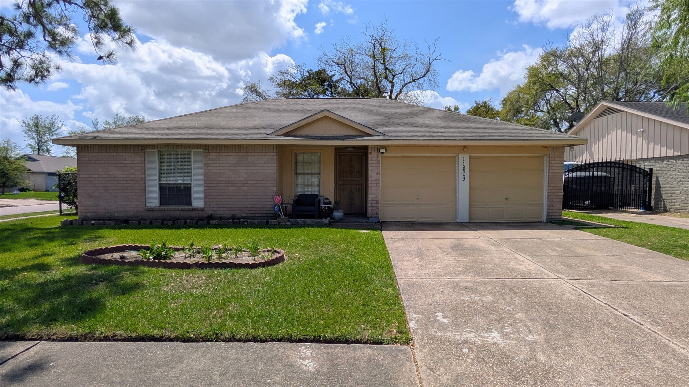 11403 Spring Grove Drive Houston, TX 77099 - Photo 2 of 23 a front view of a house with a yard and garage
