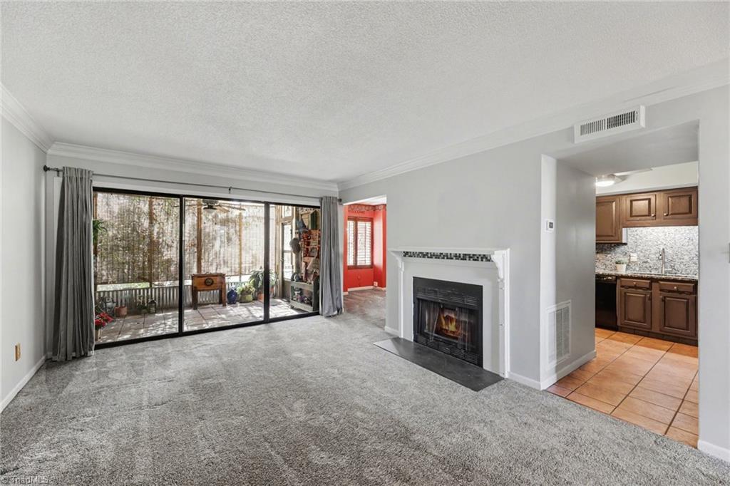 2313 Cypress Court High Point, NC 27265 - Photo 5 of 26 Spacious Living Room opens to enclosed porch and flows into the dining room and kitchen. The Fireplace has electric logs and is a great heat source as well.