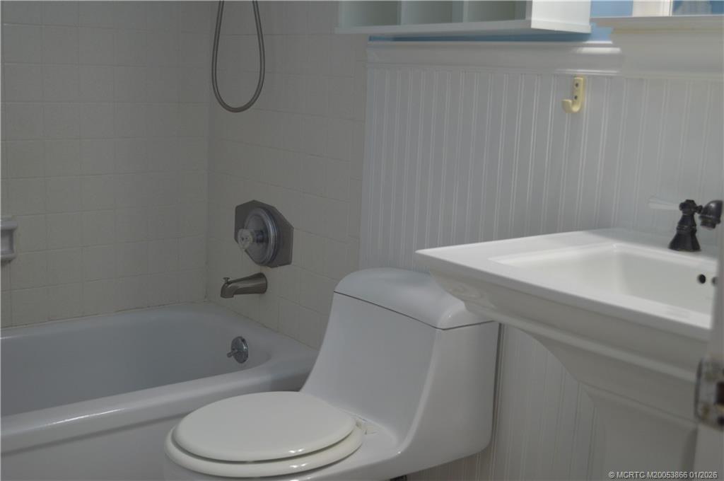 2600 Southeast Ocean Boulevard, Unit E4 Stuart, FL 34996 - Photo 15 of 47 a white toilet sitting next to a bath tub