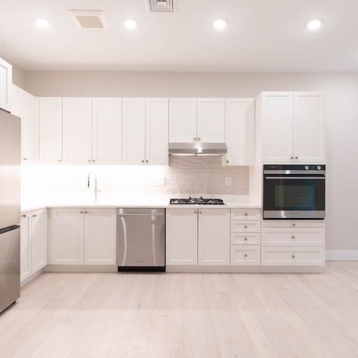 197 Green Street, Unit 202 Boston, MA 02130 - Photo 1 of 8 a kitchen with stainless steel appliances a stove a sink a refrigerator and white cabinets