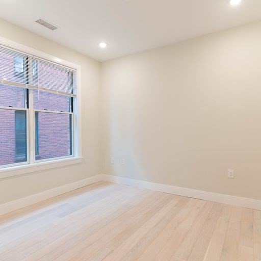197 Green Street, Unit 202 Boston, MA 02130 - Photo 5 of 8 an empty room with windows